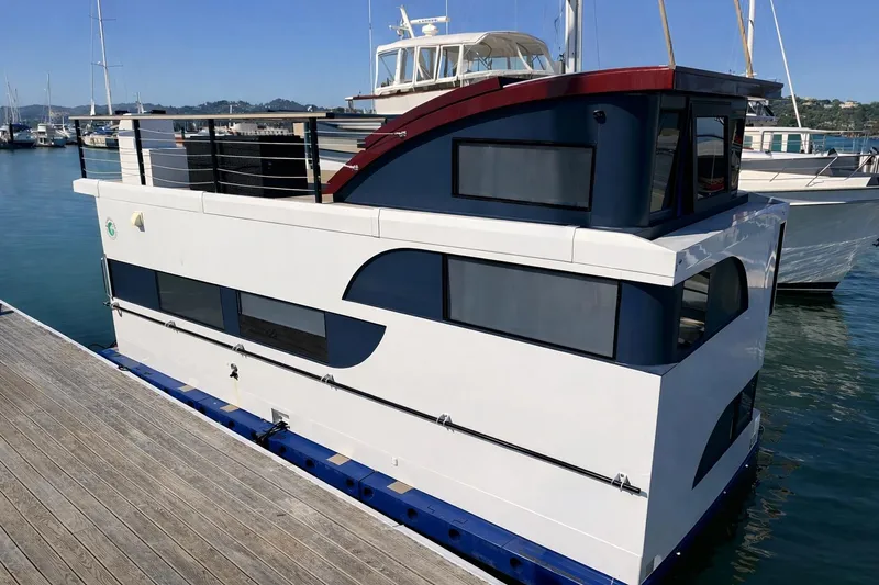The Image of Modern 2022 Navisyo NV.08 houseboat docked at marina, featuring sleek design and spacious windows. - 0