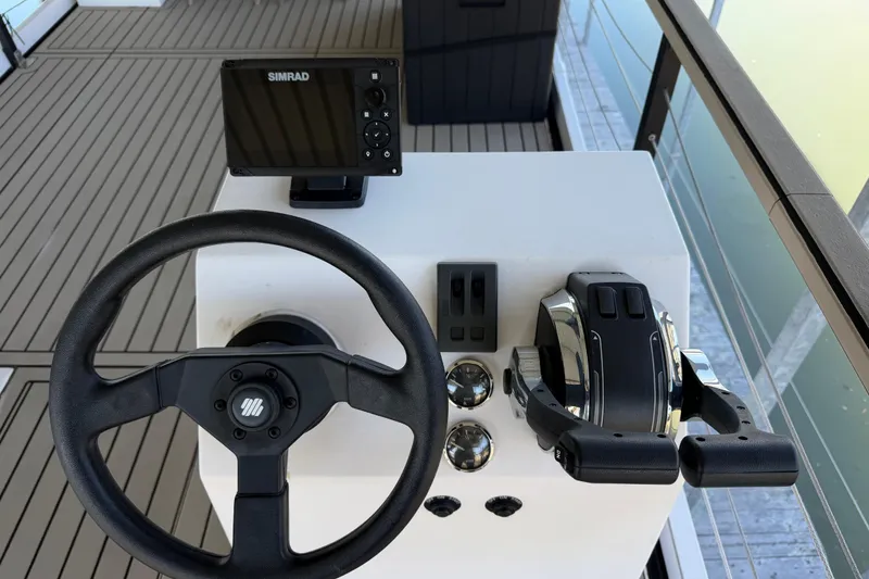 Slide: The Image of Steering console of 2022 Navisyo NV.08 with Simrad display and dual throttle controls. - 10