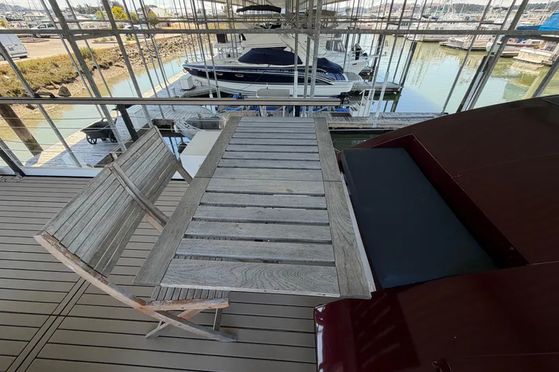 Slide: The Image of Wooden deck with table and chairs on Navisyo NV.08 yacht, 2022 model, docked at marina. - 15