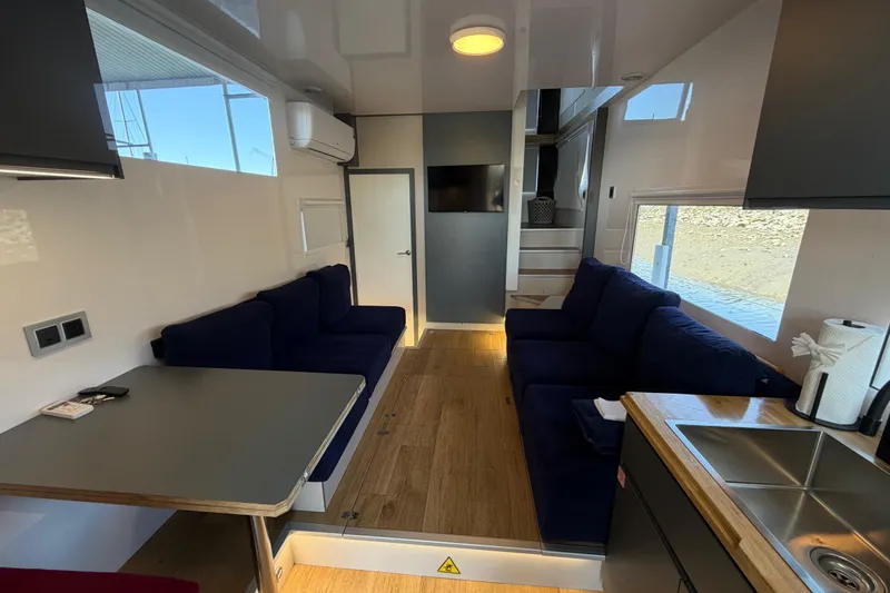 Slide: The Image of Modern interior of 2022 Navisyo NV.08 with cozy seating, kitchenette, and natural light. - 18