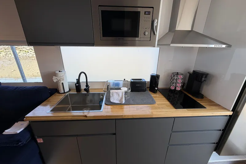 Slide: The Image of Modern kitchen in 2022 Navisyo NV.08 with sleek appliances and wooden countertop. - 22