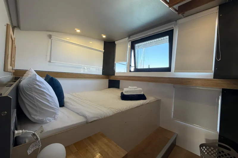 Slide: The Image of Cozy interior of 2022 Navisyo NV.08 with bed, pillows, and window view. - 25