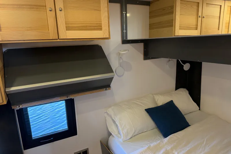 Slide: The Image of Cozy interior of 2022 Navisyo NV.08 with wooden cabinets and a comfortable bed. - 27