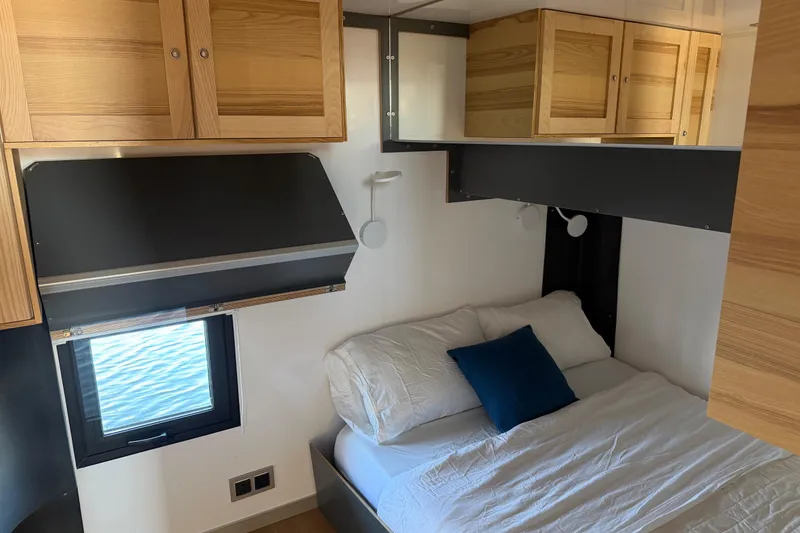 Slide: The Image of Cozy bedroom interior of 2022 Navisyo NV.08 with wooden cabinets and ocean view window. - 29