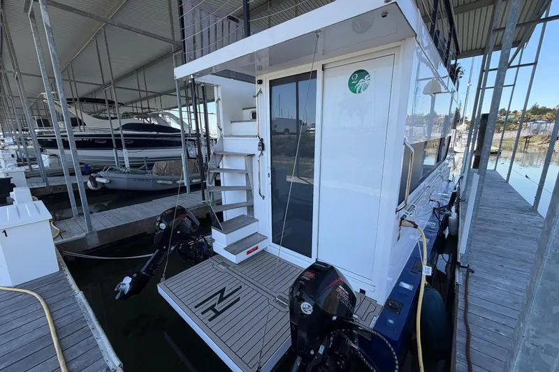 Slide: The Image of Navisyo NV.08 2022 model docked in a marina, showcasing modern design and twin outboard motors. - 5