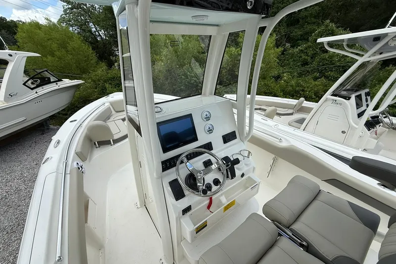 Slide: The Image of 2026 Key West 239 FS boat interior with modern dashboard and seating. - 6