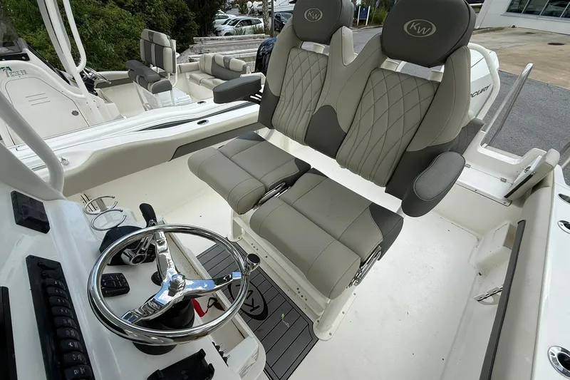 Slide: The Image of 2026 Key West 239 FS boat interior with dual seats and steering wheel. - 7