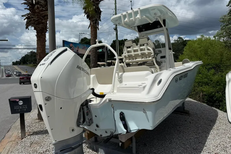 Slide: The Image of 2026 Key West 239 FS boat with Mercury engine displayed outdoors. - 2