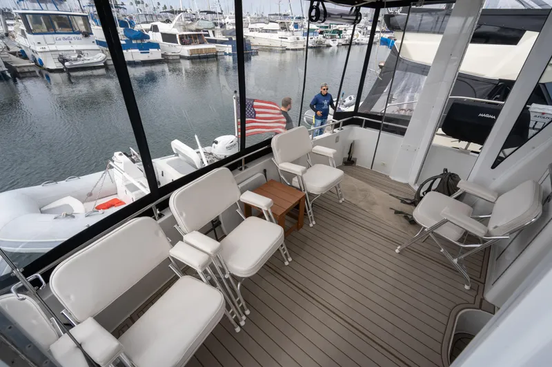 Slide: The Image of Carver 396 Motor Yacht 2001, spacious deck with seating in marina. - 11