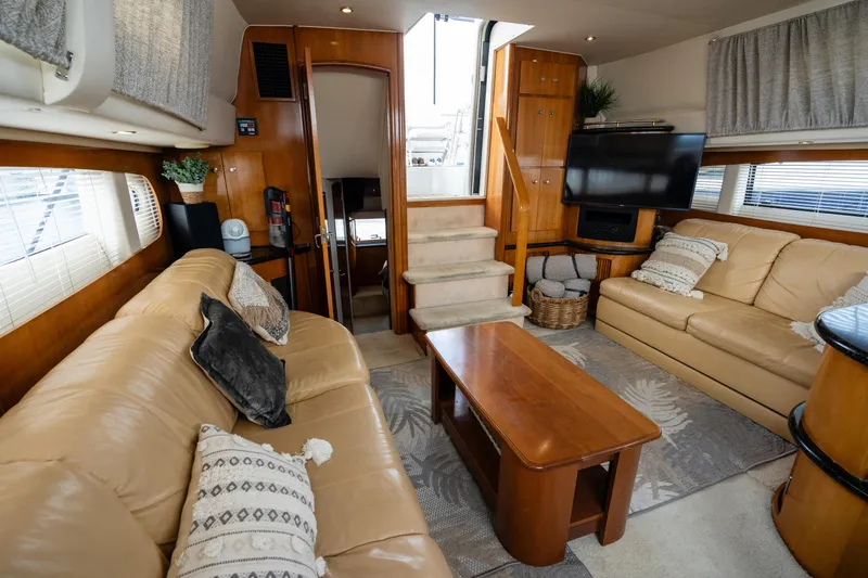 Slide: The Image of Interior of 2001 Carver 396 Motor Yacht with leather sofas and wooden table. - 17