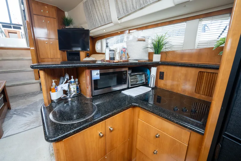 Slide: The Image of Interior of 2001 Carver 396 Motor Yacht featuring modern kitchen. - 18