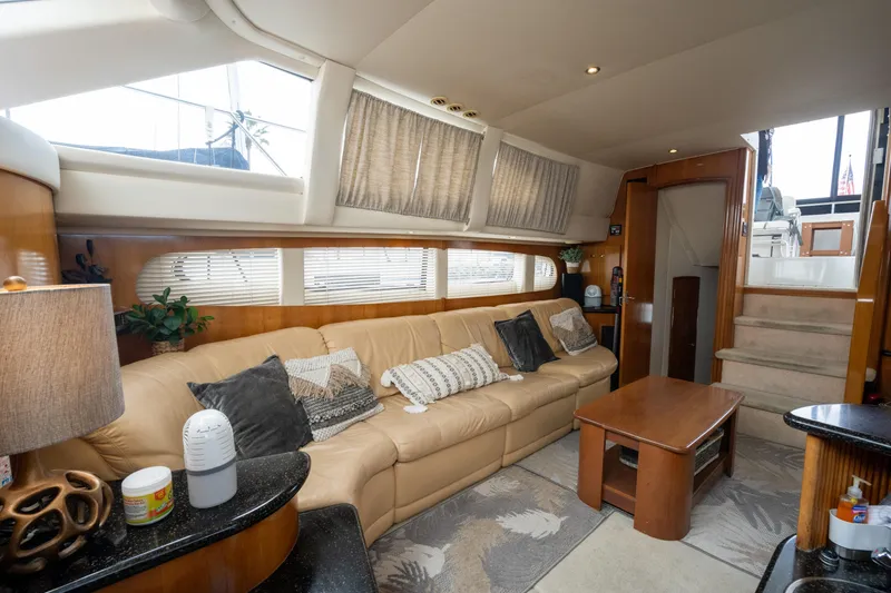 Slide: The Image of Interior of 2001 Carver 396 Motor Yacht with beige sofa and wooden table. - 19