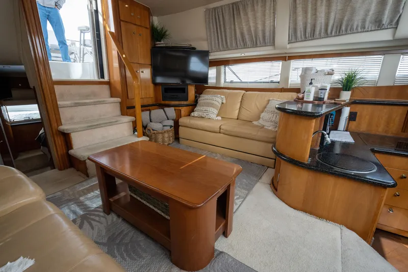 Slide: The Image of Interior of 2001 Carver 396 Motor Yacht, cozy living area with sofa and TV. - 21