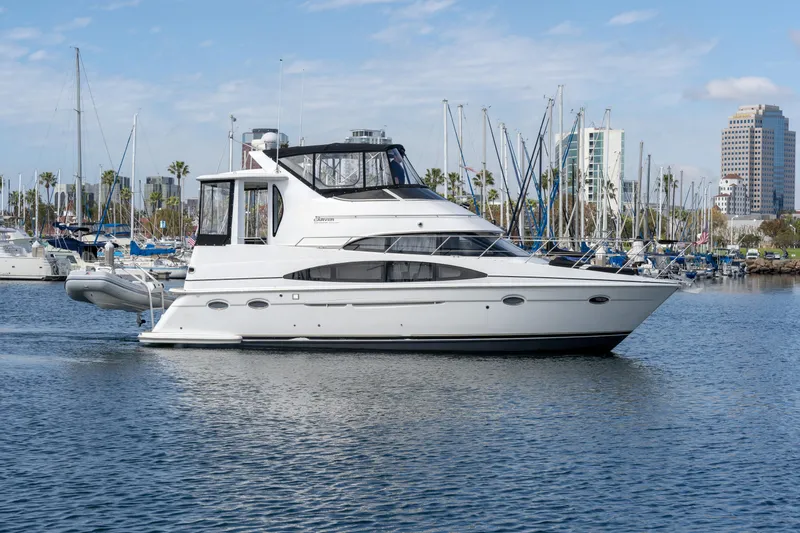 Slide: The Image of 2001 Carver 396 Motor Yacht in harbor, surrounded by sailboats. - 24