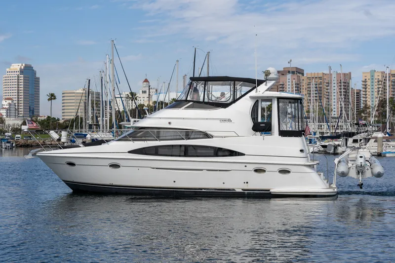 Slide: The Image of 2001 Carver 396 Motor Yacht docked with city skyline in background. - 26
