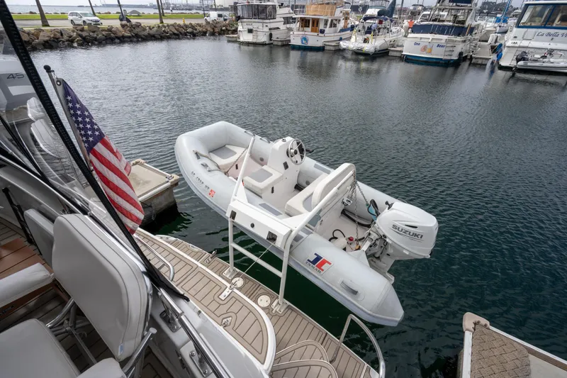 Slide: The Image of Carver 396 Motor Yacht 2001 with dinghy in harbor. - 30
