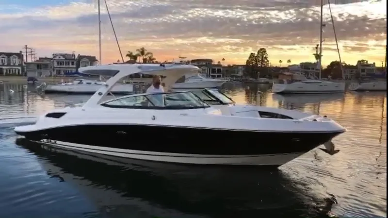 The Image of 2015 Sea Ray SLX 350 boat at sunset in the harbor. - 0