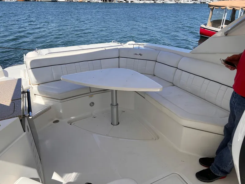 Slide: The Image of Interior of a 2015 Sea Ray SLX 350 with seating area and table. - 13