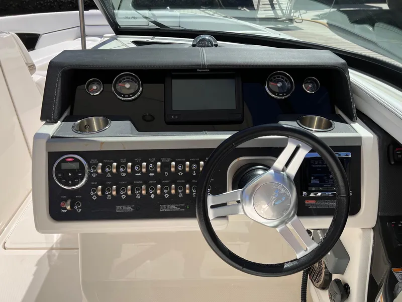 Slide: The Image of Dashboard of a 2015 Sea Ray SLX 350 boat with steering wheel and instruments. - 19