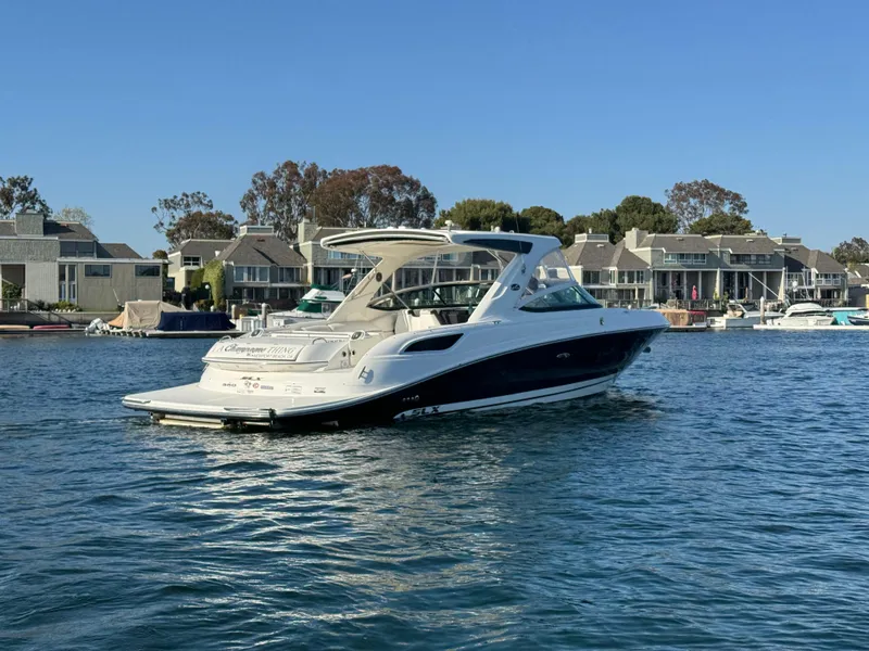 Slide: The Image of 2015 Sea Ray SLX 350 boat on calm water near houses. - 6