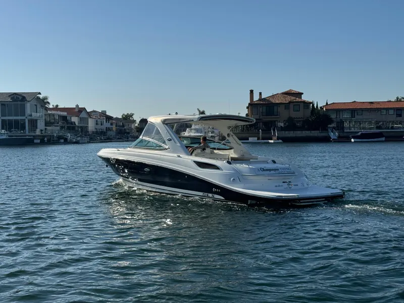 Slide: The Image of 2015 Sea Ray SLX 350 on calm water near coastal homes. - 7