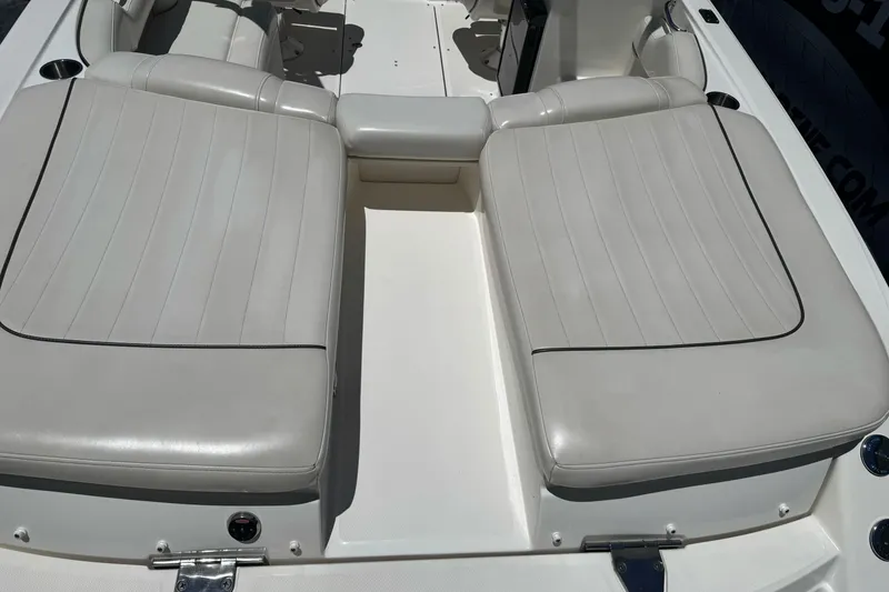 Slide: The Image of 2007 Sea Ray SLX 250 boat interior with white cushioned seating. - 10