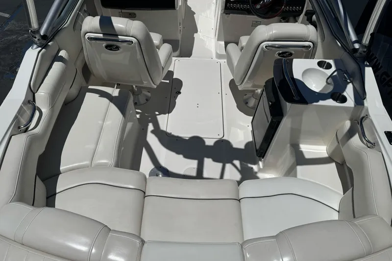 Slide: The Image of Interior of a 2007 Sea Ray SLX 250 boat with white leather seating and helm. - 12