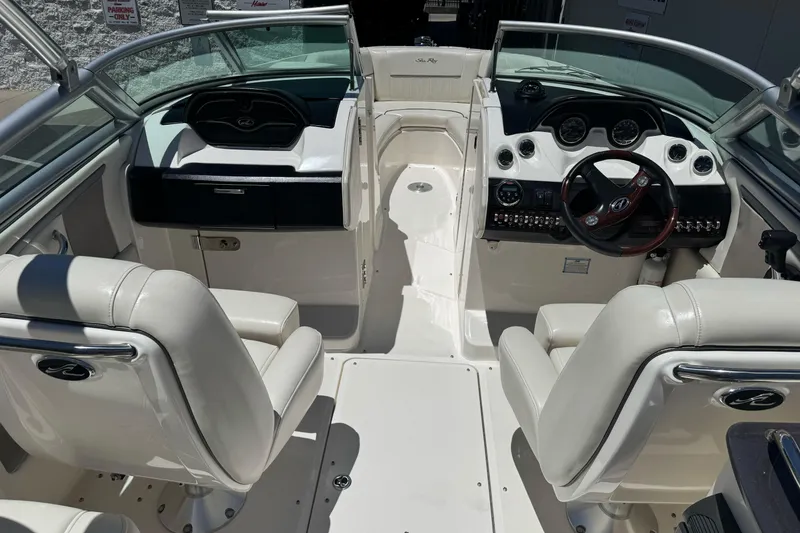 Slide: The Image of Interior view of a 2007 Sea Ray SLX 250 boat with white seating and dashboard. - 13