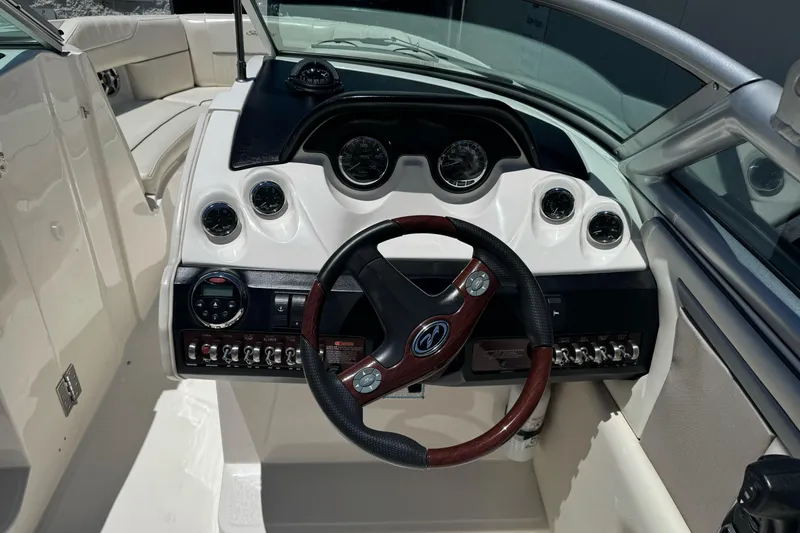 Slide: The Image of 2007 Sea Ray SLX 250 boat dashboard with steering wheel and instrument panel. - 14