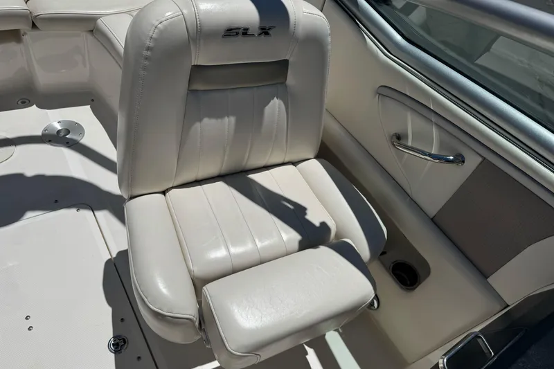 Slide: The Image of 2007 Sea Ray SLX 250 boat seat with beige upholstery and armrest. - 17