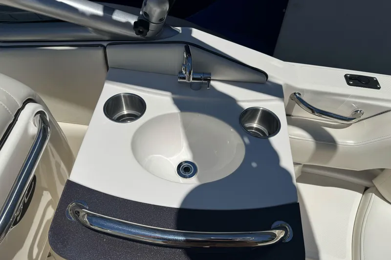 Slide: The Image of 2007 Sea Ray SLX 250 boat sink with stainless steel cup holders and faucet. - 20