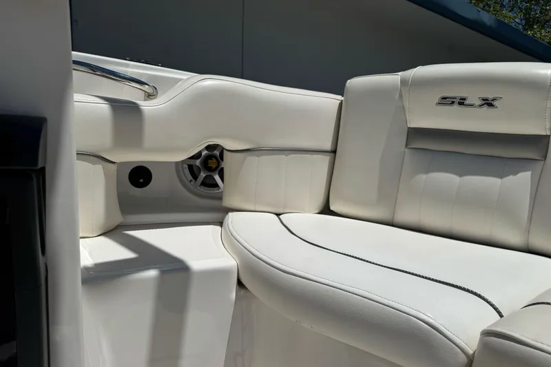 Slide: The Image of 2007 Sea Ray SLX 250 boat interior with white leather seating and speaker detail. - 22