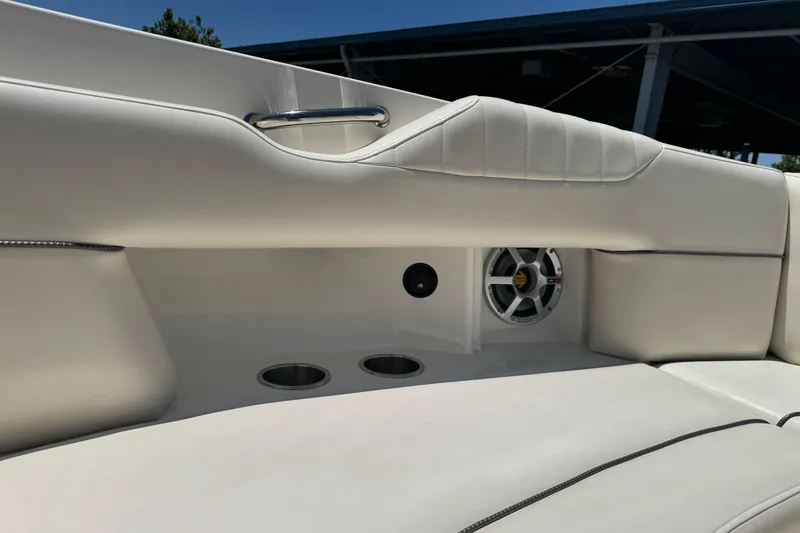 Slide: The Image of Interior of 2007 Sea Ray SLX 250 boat with white seating and speaker system. - 24