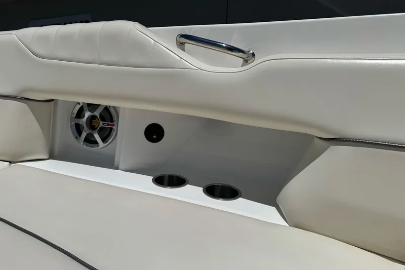 Slide: The Image of Interior of 2007 Sea Ray SLX 250 boat with white seating and speaker system. - 25