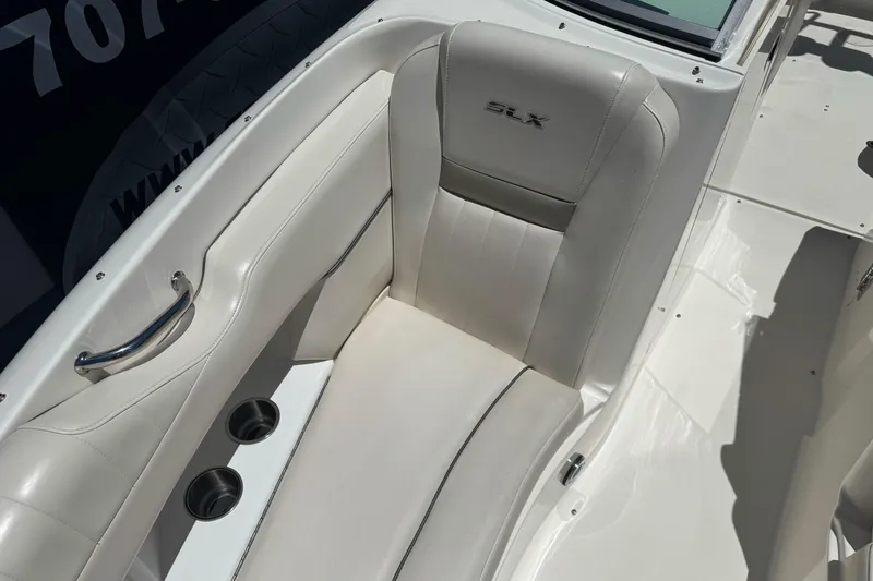 Slide: The Image of 2007 Sea Ray SLX 250 boat interior with white leather seating and cup holders. - 27