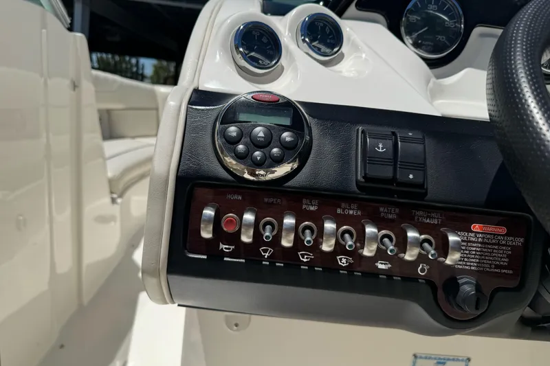 Slide: The Image of Control panel of a 2007 Sea Ray SLX 250 boat with various switches and gauges. - 28