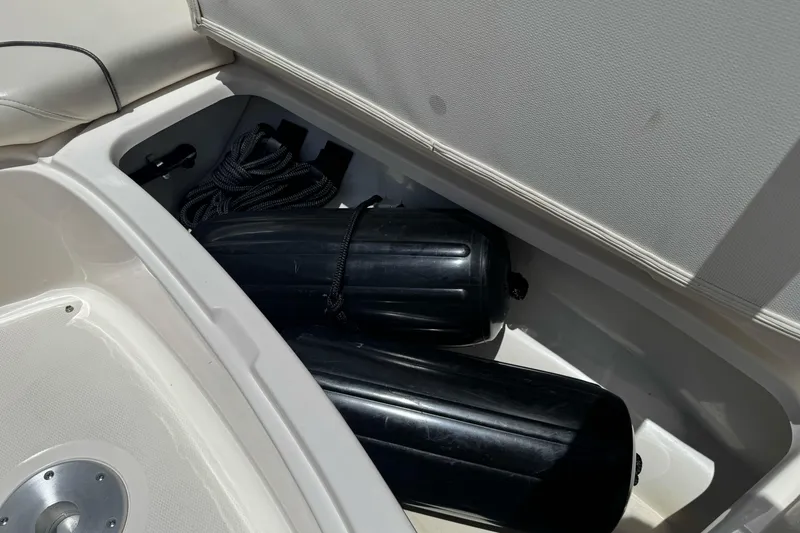 Slide: The Image of Storage compartment of a 2007 Sea Ray SLX 250 boat with black fenders and rope. - 29