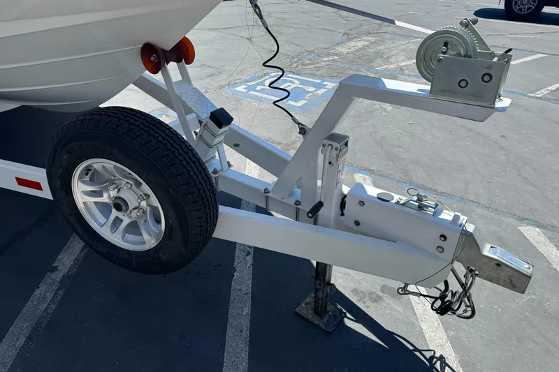 Slide: The Image of Trailer hitch and wheel of a 2007 Sea Ray SLX 250 boat in a parking lot. - 3