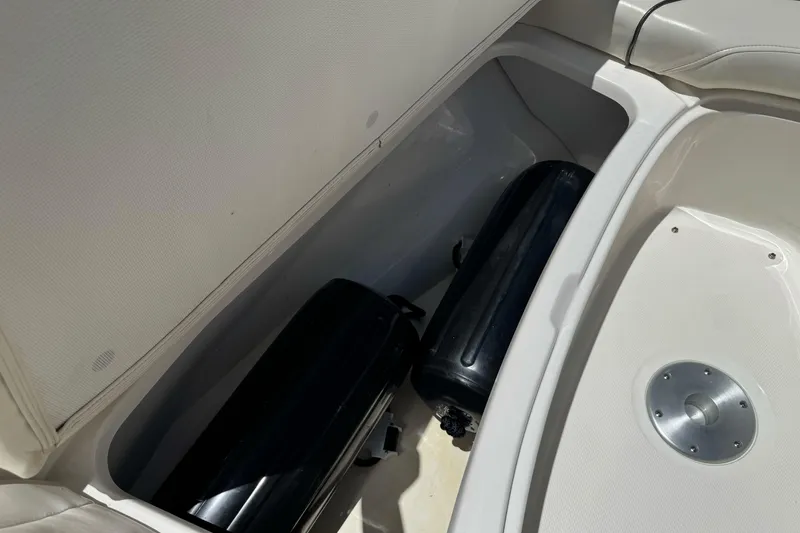 Slide: The Image of Storage compartment of a 2007 Sea Ray SLX 250 boat with black fenders inside. - 30