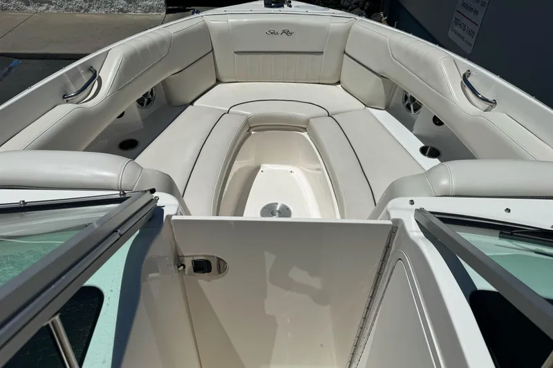 Slide: The Image of 2007 Sea Ray SLX 250 boat interior with white leather seating and open deck. - 31