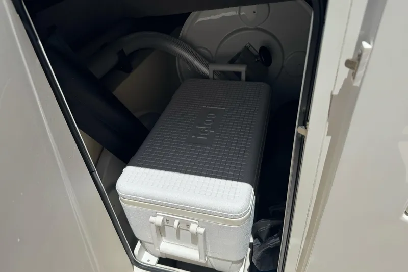 Slide: The Image of Storage compartment in a 2007 Sea Ray SLX 250 boat with an Igloo cooler inside. - 32
