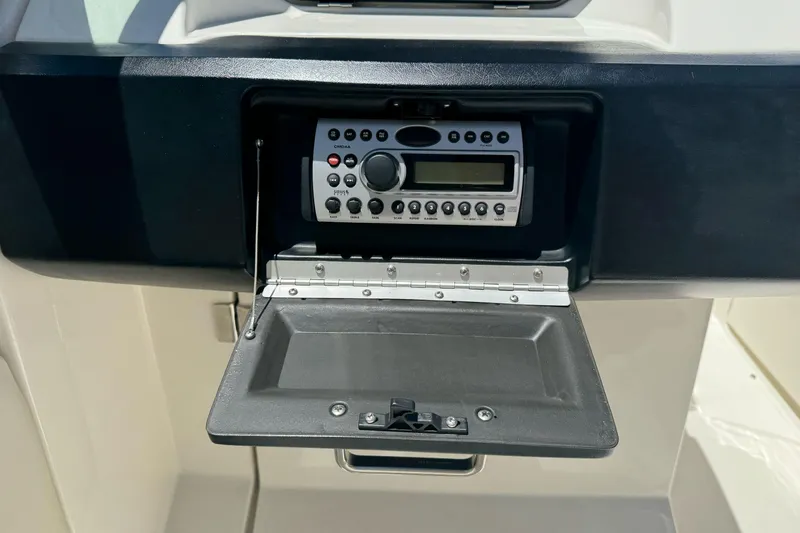 Slide: The Image of 2007 Sea Ray SLX 250 boat stereo system with open compartment. - 33