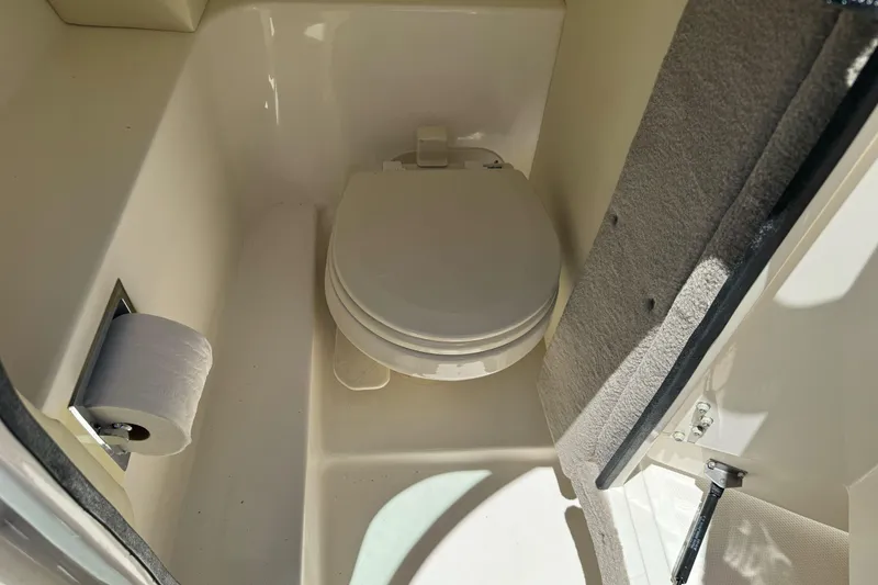 Slide: The Image of 2007 Sea Ray SLX 250 boat bathroom with toilet and toilet paper holder. - 35