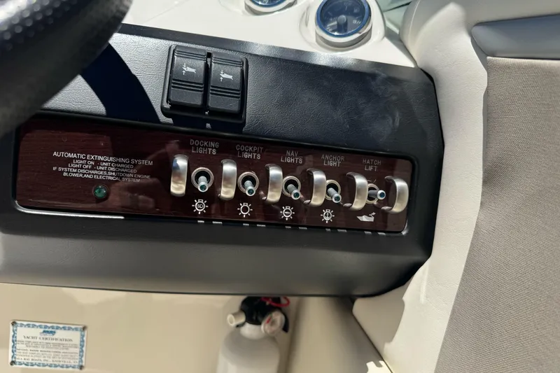Slide: The Image of Control panel of a 2007 Sea Ray SLX 250 boat with various switches and gauges. - 37