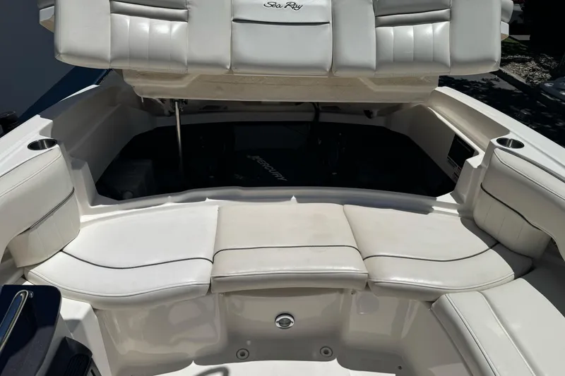 Slide: The Image of 2007 Sea Ray SLX 250 boat interior with white cushioned seating and open storage compartment. - 38
