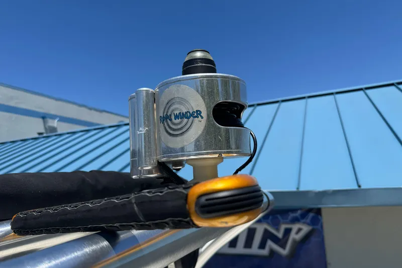 Slide: The Image of Rope winder device on a 2007 Sea Ray SLX 250 boat against a clear blue sky. - 45