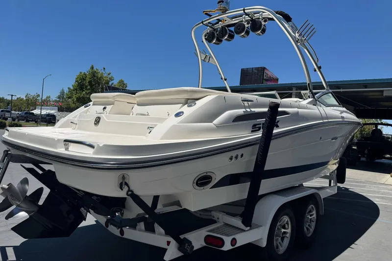 Slide: The Image of 2007 Sea Ray SLX 250 boat on trailer, rear view, under clear blue sky. - 5