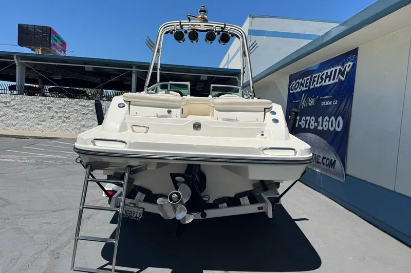 Slide: The Image of 2007 Sea Ray SLX 250 boat parked at a marina with a visible ladder. - 6