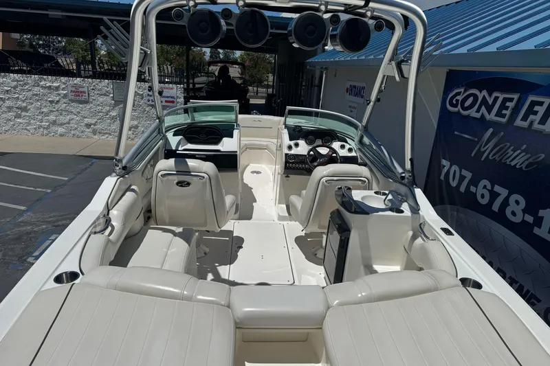 Slide: The Image of 2007 Sea Ray SLX 250 boat interior with white seating and modern dashboard. - 9