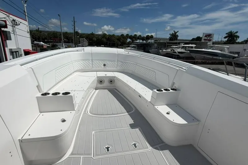 Slide: The Image of 2020 Intrepid 375 Nomad SE boat interior with spacious seating and cup holders. - 3
